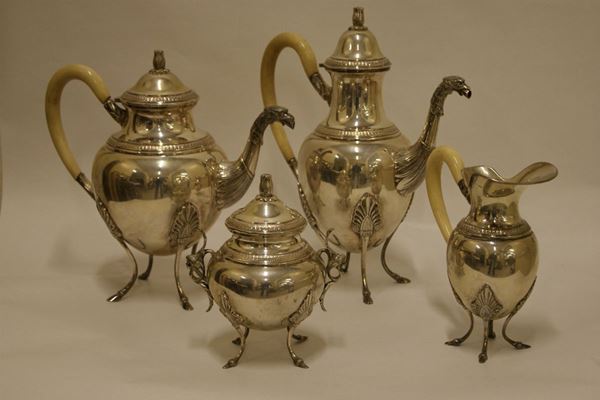 Servito da te' e caffe' sec.XX, in argento composto da caffettiera e teiera con manici in avorio e beccucci cesellati a teste di aquile, zuccheriera con manici a testine di putti, lattiera con manico in avorio, g 3000