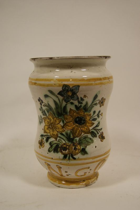 Albarello, sec. XVIII, in terracotta smaltata e decorata a fiori, alt. cm 16