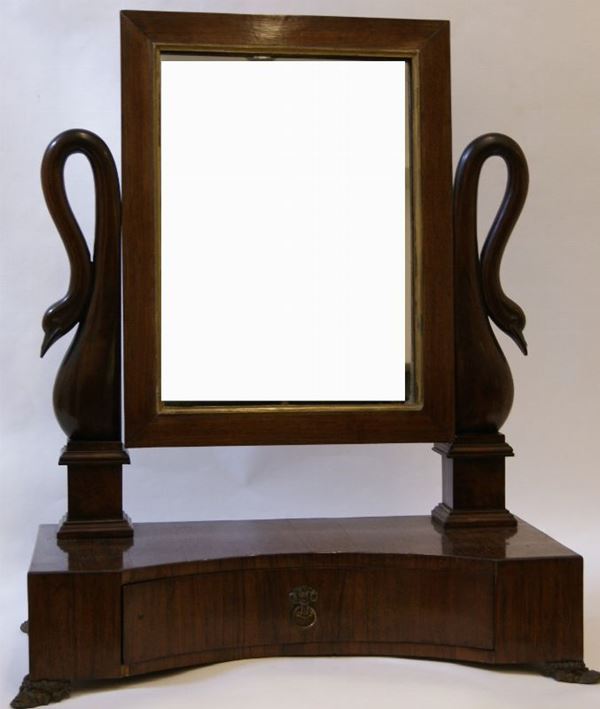 Specchiera a bilico, Impero sec. XIX, in legno , sorretta da due teste di cigni con base sagomata ad un cassetto e piedi in metallo, cm 72x40x84