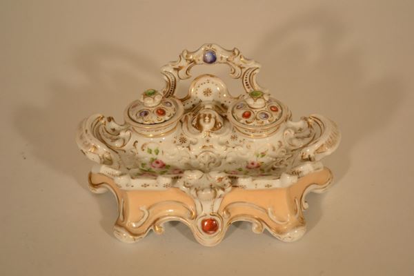 Calamaio, seconda metÃ   sec. XIX, in porcellana a fondo crema dipinta in policromia con rose e lumeggiata oro, parte superiore modellata a mascherone, cm 10,5x20,5x13, danni e abrasioni