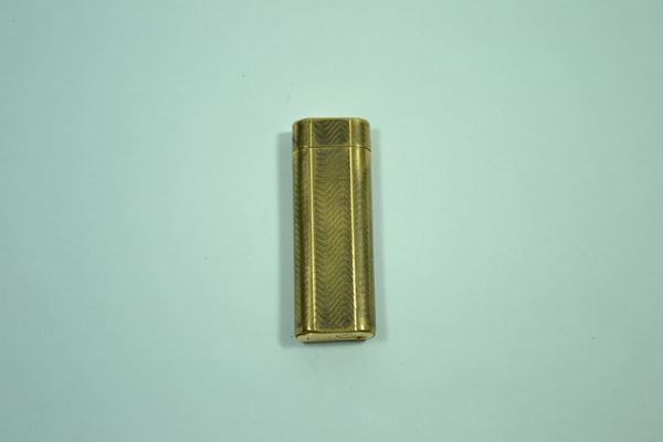 Accendino Cartier in metallo dorato, consunto