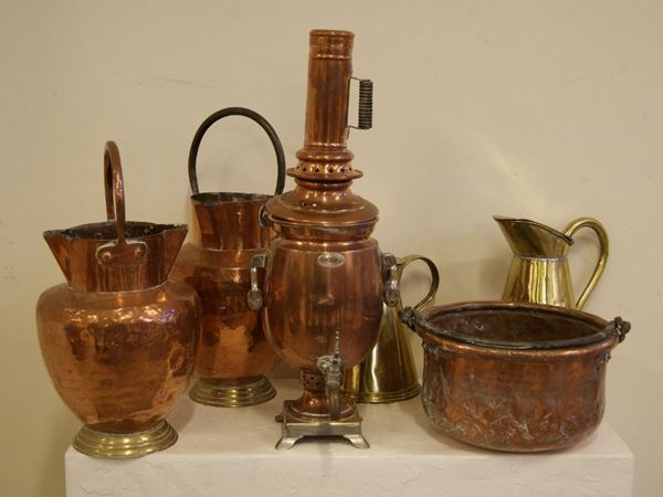 Coppia di versatoi, sec. XIX, in rame con manico rigido arcuato, base scalettata circolare in ottone, alt. cm 46 e alt. cm 42 e  due Versatoi di differente misura in ottone con coperchi piatti, manici a voluta ed una Pentola circolare, sec. XIX, in rame con manico snodabile, diam.  cm 31, vari danni alla pentola; Samovar in rame e ottone con manici snodabili in metallo e legno, rubinetto frontale con chiusura traforata e base quadrata su piedini mossi con placchetta iscritta, fine sec. XIX, alt. cm 54  (6)