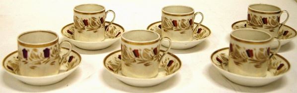 Piccolo servito da caffe', inizio sec. XIX, composto da sei tazzine e sei piattini, in porcellana decorata in policromia con motivi di fiori, bordi e fogliami in oro, manico a forma di voluta, danni(12)