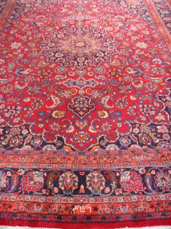 Tappeto persiano mashad, firmato, di vecchia manifattura, fondo rosso, campo a motivo floreale con medaglione centrale e bordura blu e rosso, cm 400x300