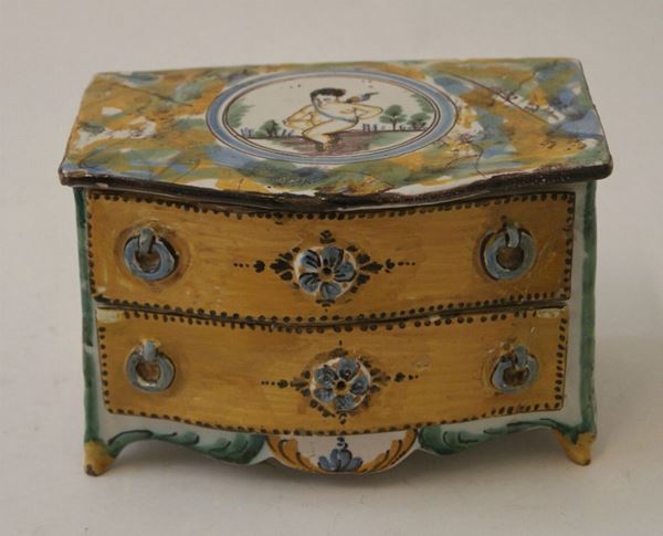 Cassettoncino, in maiolica, a due cassetti, dipinto nei toni del giallo, del verde e del blu, cm 17x11,5x11