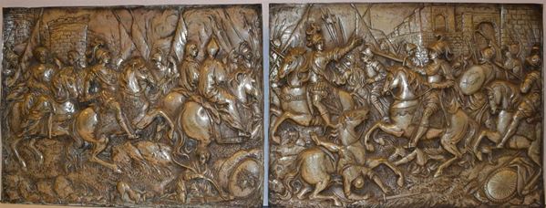 Coppia di bassorilievi,  sec. XIX, siglati EB,  in argento sbalzato e       cesellato a Scene di battaglia e edifici fotificati nello sfondo, cm 30x41  (2)