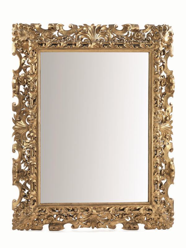 Grande cornice, in stile Cinquecento, sec. XIX in legno intagliato e dorato di forma rettangolare decorata a volute di foglie d'acanto, frutta e fiori  e mascheroni fantastici angolari, luce cm 129x97, alcuni danni e mancanze  - Asta Antiquariato, Collezionismo & Gioielli - Poggio Bracciolini Casa d'Aste