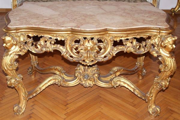 Tavolo, primi sec. XX, in legno intagliato con testine e dorato, piano in marmo, cm 128x80x77  - Asta Antiquariato, Collezionismo & Gioielli - Poggio Bracciolini Casa d'Aste
