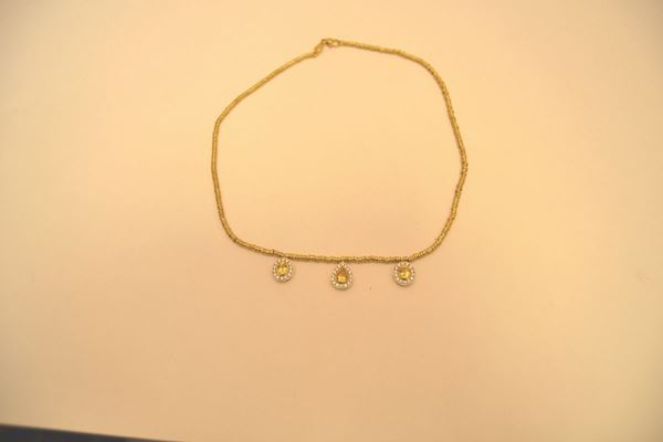 Girocollo in oro giallo a rondelle con tre pendenti con zaffiri gialli e brillanti,marcato Torrini, peso gr 21,5 brillanti 0,7 k zaffiri 2,1 k
