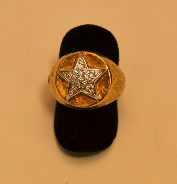 Anello in oro giallo e bianco con pavÃ¨ di brillanti montati a stella, marcato Torrini, peso grammi 11,5 brillanti per 0,18 K