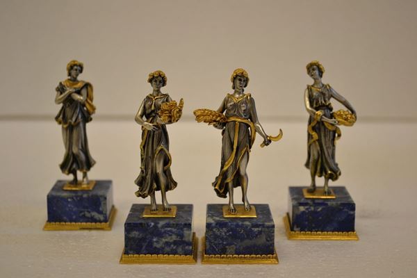 Quattro statuine, in argento, raffiguranti le quattro stagioni, su basi     quadrate in lapislazzuli (4)