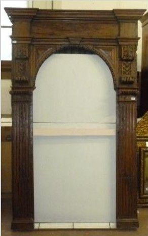 Cornice da altare, Italia centrale, sec. XVII, in noce intagliato a patina scura, cimasa modanata, parte centrale centinata inquadrata da due mensoloni a volute su lesene scannellate, cm 221x136, piccoli restauri