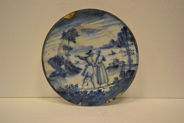 Piatto, Genova, sec. XVIII, in maiolica decorata in monocromo blu, diam. cm 31, ricomposto