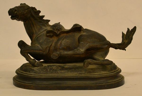 Piccola scultura, Fonderia Cappellini, Pistoia sec. XIX, in bronzo a patina scura, modellata come un cavallo a terra sellato per la battaglia, base in bronzo du forma ovale gradinata, alt. cm 14,5