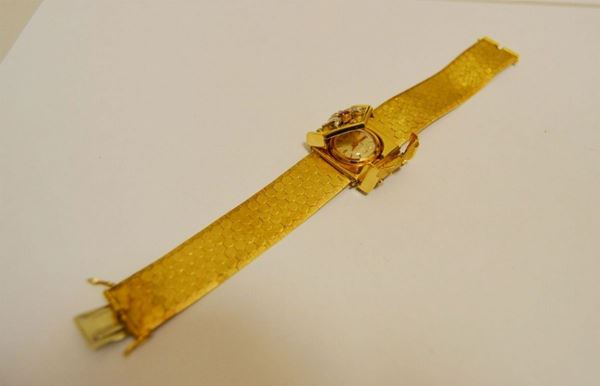 Bracciale in oro giallo, con orologio a scomparsa, marcato OMEGA, e cerniera decorata a brillanti, g 66,5