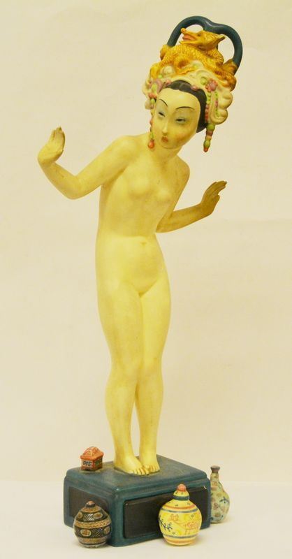 Scultura con figura di orientale, sec. XX, in ceramica, manifattura LENCI, con piccolo cassettino e vasetti a rilievo sulla base, reca numerazione 369, cm 45, difetti sul cassettino