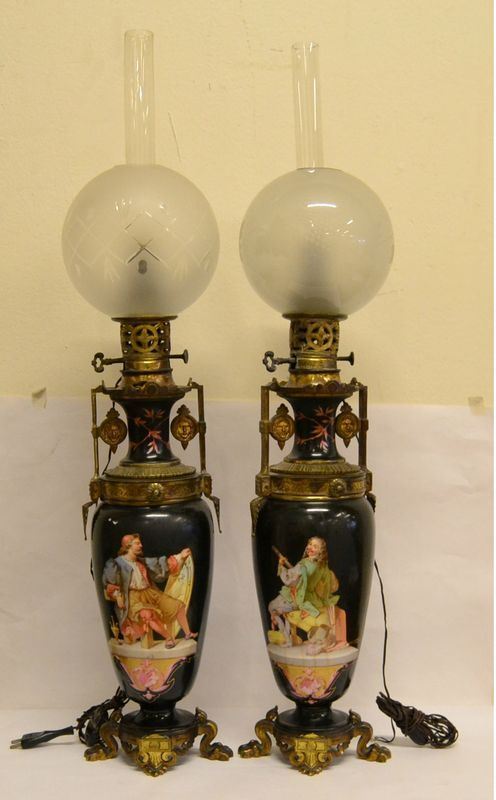 Coppia di vasi, Francia, sec. XIX, in metallo dorato e ceramica decorata a personaggi, campana in vetro, alt. cm 83, difetti