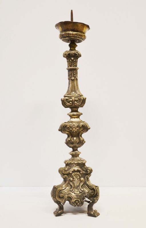 Portacero, sec. XVIII, in metallo argentato, fusto a balaustro sbalzato a   volute su base tripode, alt. cm 77