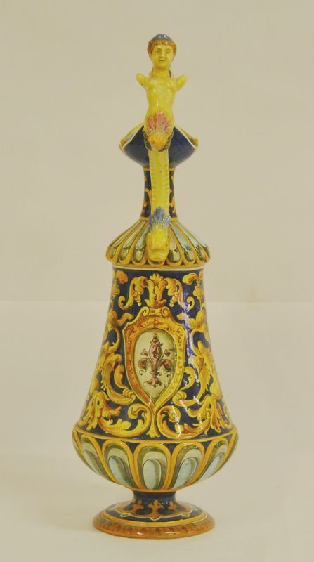 Brocca versatoio, sec. XX, in maiolica, decorato a motivi vegetali, con manico a figura femminile, alt. cm 49
