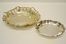 Due vaschette, sec. XX, in argento rispettivamente di forma ovale sagomata, cm 19,5x16,5 e di forma circolare con tesa ondulata, diam. cm 29,5, complessivi g 500