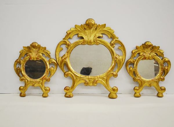 Tre cartaglorie, sec. XIX, in legno intagliato e dorato con cornici a volute, trasformate in specchierine, cm 37x38 e cm 25x24