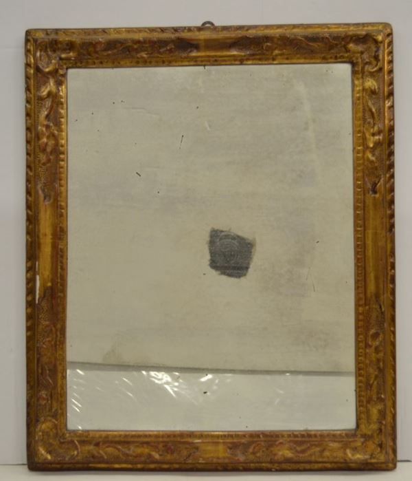 Piccola cornice, Veneto, fine sec. XVIII, in legno intagliato e dorato di forma rettangolare con volute, montata a specchiera, cm 43x34 e cornice, sec. XIX, in legno ebanizzato e dorato, cm 30x40