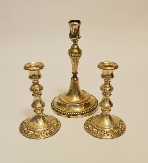 Candeliere, sec. XIX, in argento g 270 e  Coppia di candelieri sec. XIX in argento, alt cm 15 e cm  22 (3)