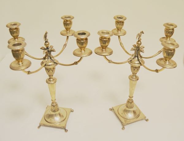 Coppia di candelieri in argento a 4 bracci con finale ad aquila  base quadrata, gr 1644, alt cm 34