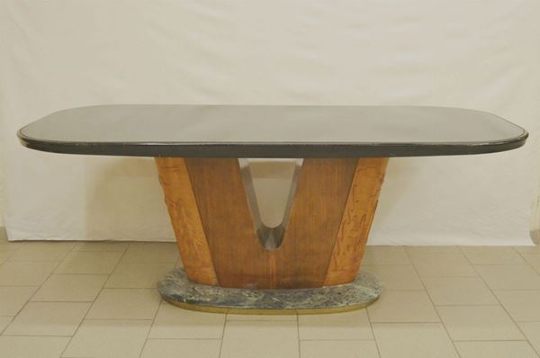 Tavolo da pranzo, anni '40, in legno, piano ovale con vetro poggiante su tronco intagliato a forma di V, base in marmo, cm 203x92x79