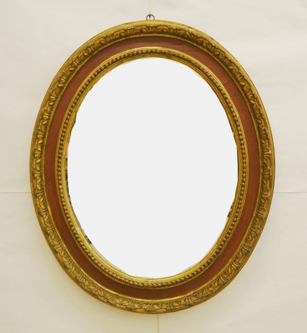 Specchiera ovale, Francia, sec. XIX, in cornice dorata e intagliata, cm 140x120