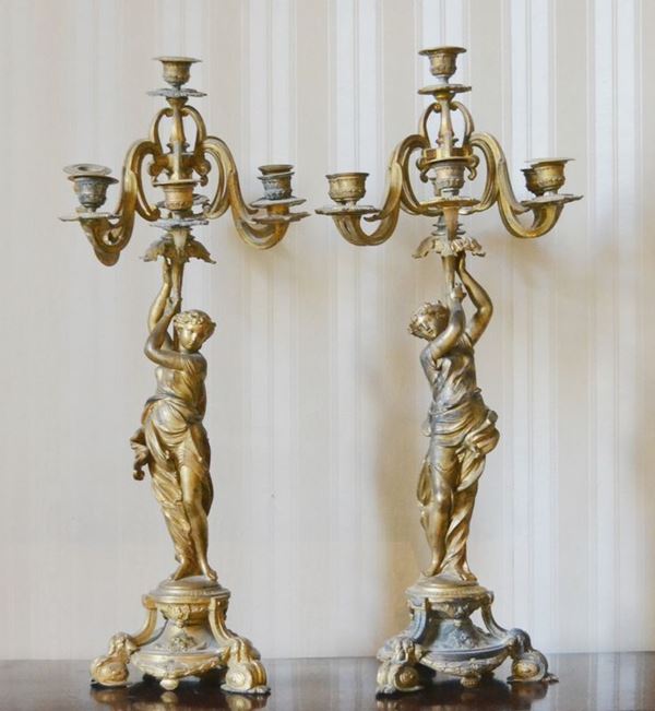 Coppia di candelieri, sec. XIX, in metallo dorato, a sette fiamme, fusto centrale modellato a figura femminile, alt. cm 65 ( 2 )