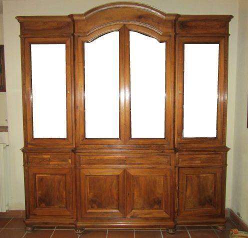 Vetrina, Toscana, sec. XIX, in noce a due corpi, otto sportelli di cui quattro in  vetro, tre cassetti, piedi a cipolla, cm 237x44x260
