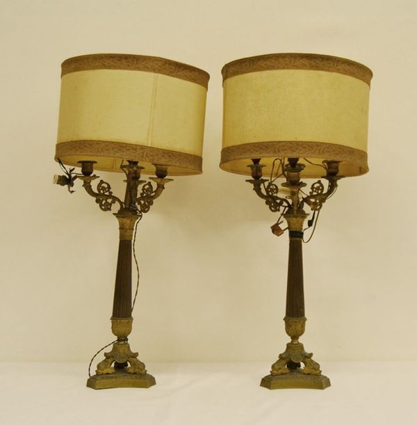 Coppia di candelieri, stile Impero, in bronzo, a tre bracci, fusto scanalato, piedi a testa di pesce, alt. cm 56