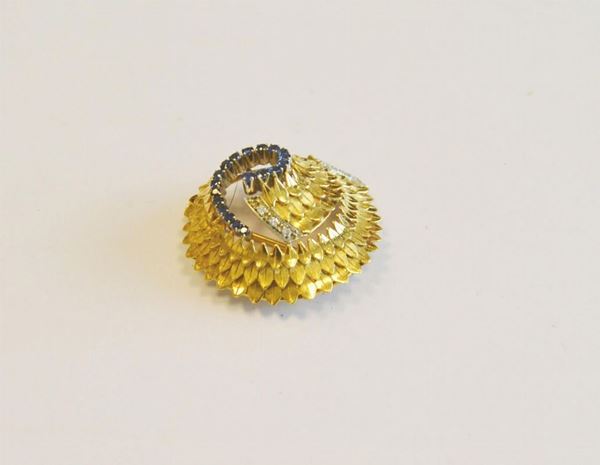 Spilla in oro giallo, zaffiri e diamanti lavorata a voluta con motivi a foglia cesellati profilata da zaffiri e diamanti huit huit, g 11                                                   