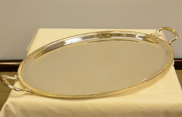 Guantiera, sec. XX, in argento, di forma ovale con bordo a palmette, due anse, cm  62x38, g 1980                                                              