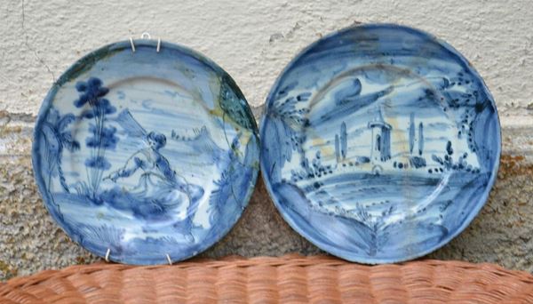 Due piatti, Savona, sec. XVIII, in maiolica, decorati a PAESAGGI, cm 23x25, rotture e restauri ( 2 )