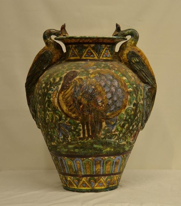 Vaso, inizi sec. XX, in maiolica policroma, due manici a forma di pavoni, alt. cm 70