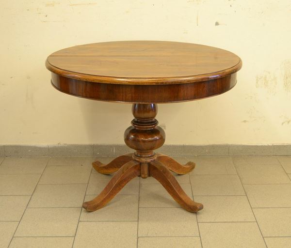  Tavolo, Toscana, sec. XIX,  in noce, piano circolare allungabile, 