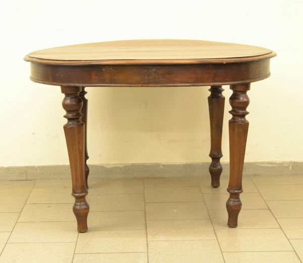  Tavolo, Toscana, sec. XIX,  in noce, piano circolare allungabile.