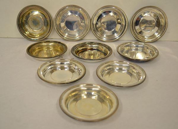 Dieci sotto bicchieri in argento, bordi sbalzati, complessivi&nbsp; g 627 (10)