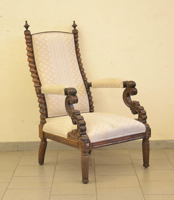Poltrona, fine sec. XIX, in noce intagliato, colonne tornite,