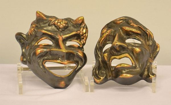 Due maschere, sec. XX, in bronzo dorato,