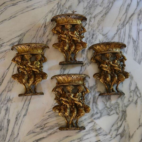 Quattro applique, sec. XX, in bronzo modellato