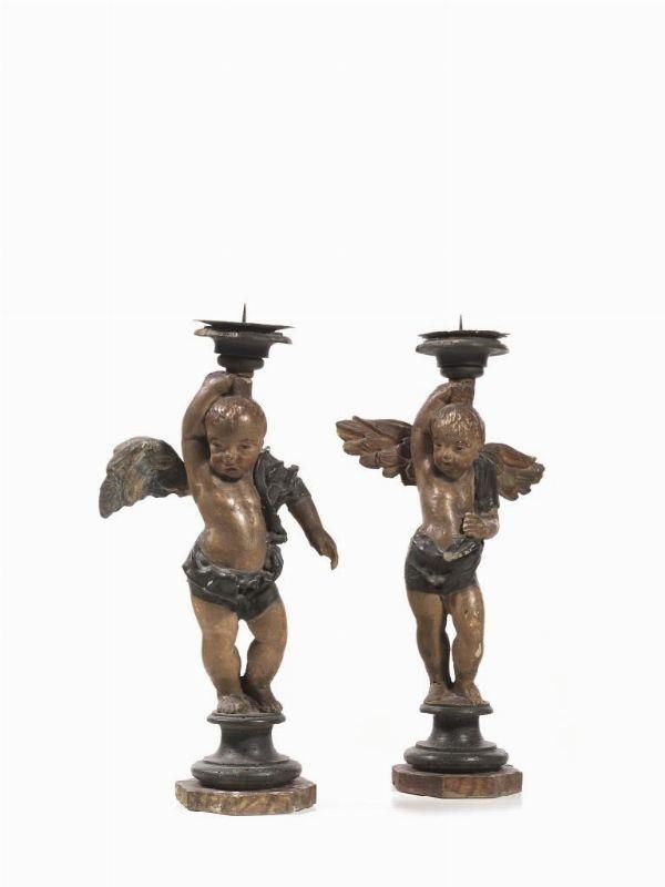 Coppia di sculture, sec. XVIII, in legno intagliato e