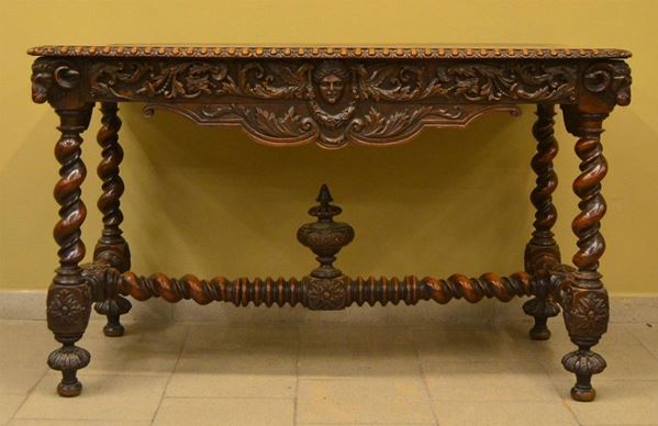 Tavolo, inizi sec. XX, in legno intagliato a mascheroni e