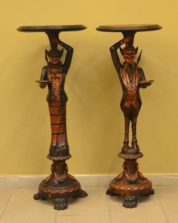 Coppia di gueridon, inizi sec. XX, in legno intagliato a figure di satiri,