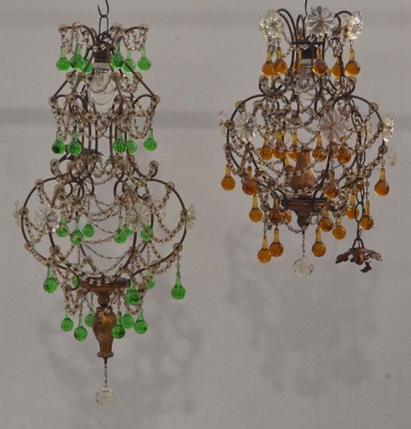 Due lampadari, inizi sec. XX, in metallo e legno con gocce colorate,&nbsp;&nbsp;&nbsp;&nbsp;&nbsp;&nbsp;