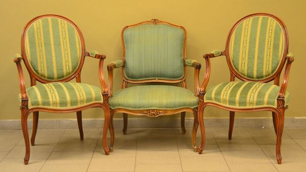 Tre poltroncine, sec. XX, in noce sagomato,                               