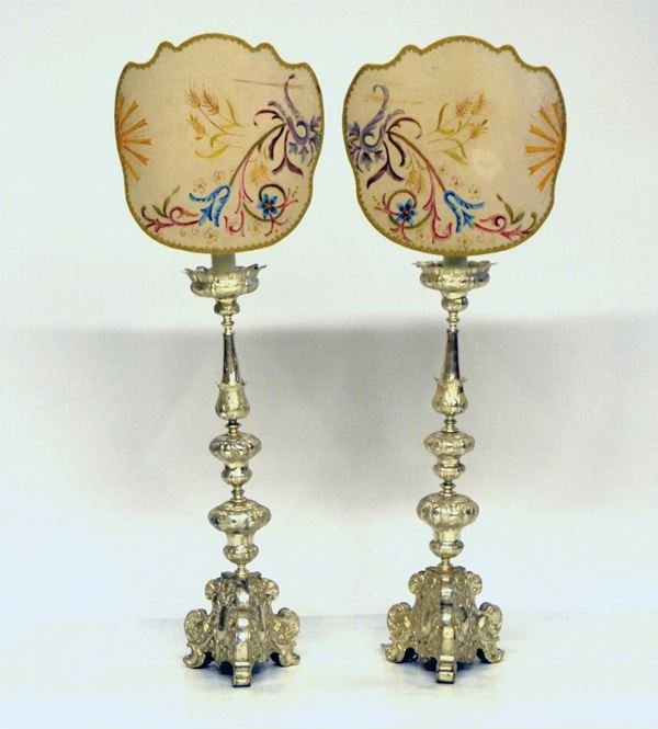 Coppia di candelieri, sec. XX, in metallo argentato e lavorato,