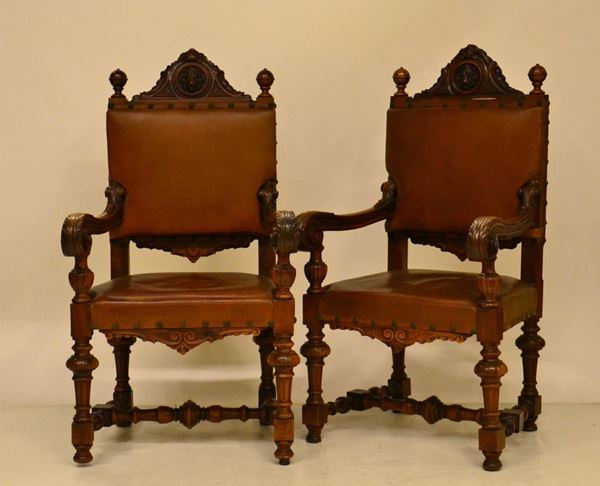 Coppia di poltrone, inizi sec. XX, in noce intagliato,